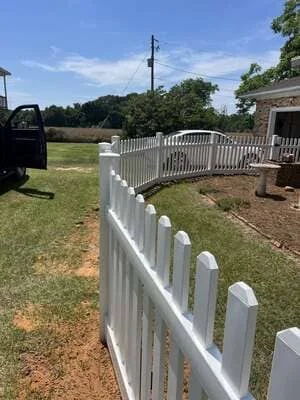 White vinyl picket fence with post caps installed along residential property in Headland, AL