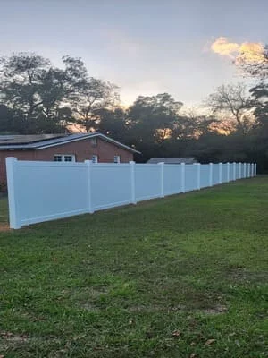 White vinyl privacy fence installed along residential property in Headland, AL